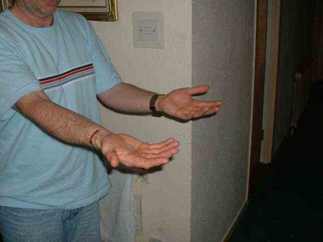 Spectator is asked to open their hands where they see that the ash has appeared to penetrate through to their palm.
