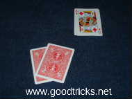 Spectator selects two cards from a row of three that he can see on the table.