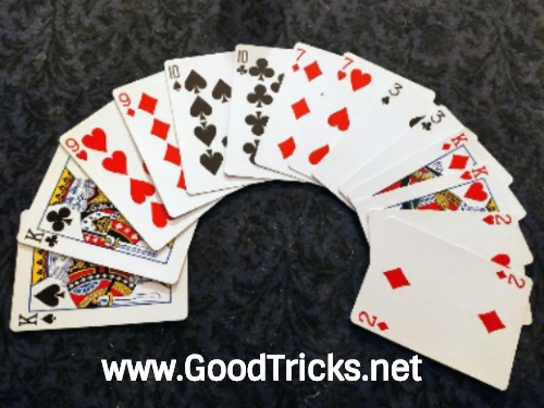Image of fanned deck of playing cards set up in pairs in preparation for a card trick.