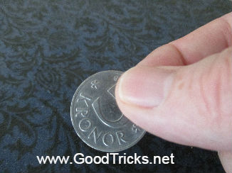 A small coin is made to appear in different places like magic.
