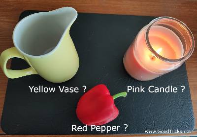 Yellow vase, red pepper and pink candle magic props. 