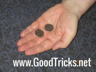 Hand is opened to reveal only two coins.