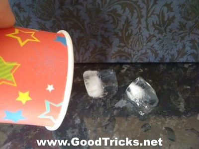 Ice cubes are poured out from the magic cup.