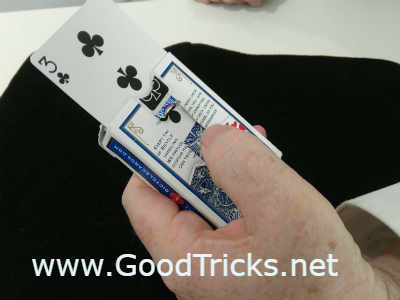 Hold out card in front of spectator and push up card with thumb.