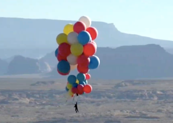 David Blaine, riding balloons, high in the air over the Arizona desert.