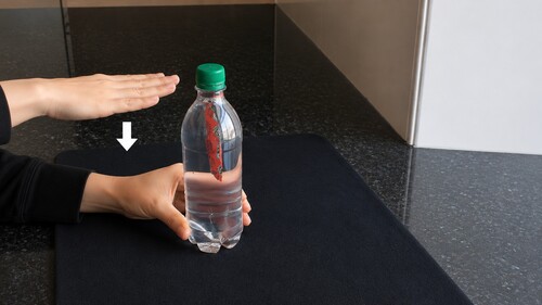 Remote controlling the movement of a sachet in a sealed bottle.