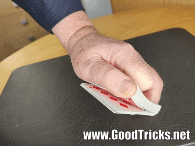 Playing cards being  riffled through with slight pressure from your thumb.